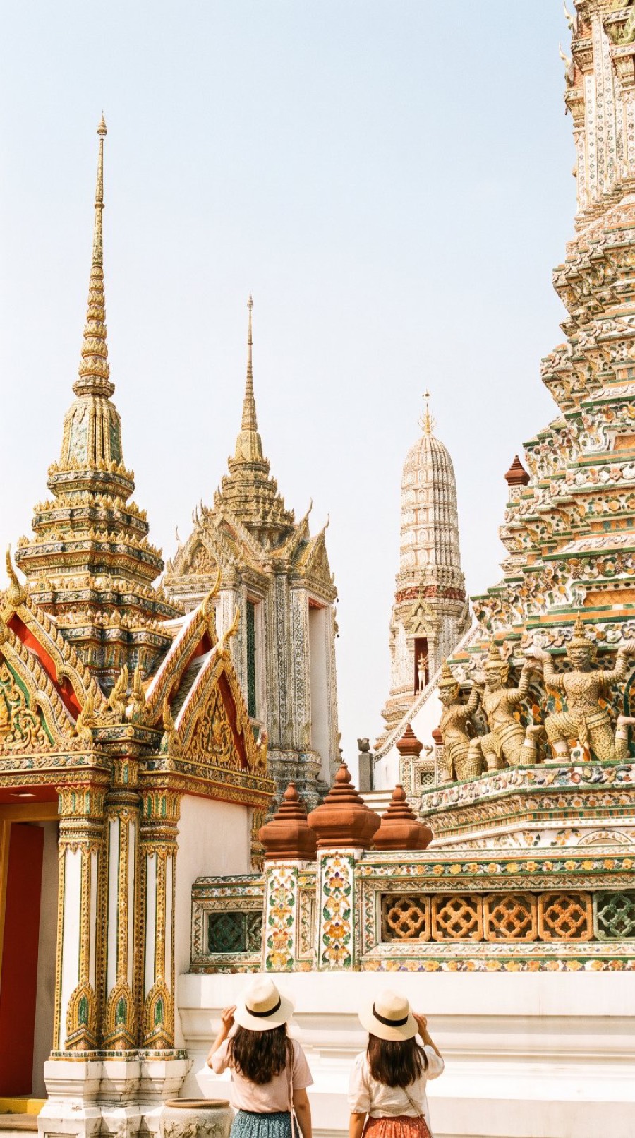 Travelers at ornate temples under a clear sky